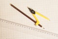 Yellow Drawing compass with black pencil and ruler on graph Royalty Free Stock Photo