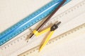 Yellow Drawing compass with black pencil and rulers on graph pap Royalty Free Stock Photo