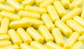 Yellow drug capsules macro Royalty Free Stock Photo