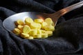 yellow drugs on spoon with black background