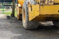 Yellow drum roller machine vehicle parking in the middle of city park