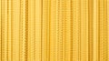 Yellow dry mafaldine pasta background Royalty Free Stock Photo