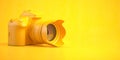 Yellow DSLR photo camera on yellow background Royalty Free Stock Photo