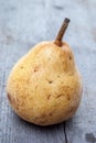 Yellow duchesse pear on wood