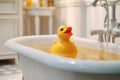 Yellow duck toy in the bathtub. Bath time concept. Generative AI Royalty Free Stock Photo