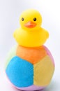 Yellow duck toy on toy soccer ball with white background Royalty Free Stock Photo