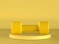 Yellow dumbbell on yellow background