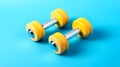 Yellow dumbbells on light blue background. Rubber fitness weights for home training. Home fitness or sport center equipment to Royalty Free Stock Photo