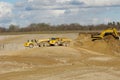 Yellow dump trucks and excavator are working in pit Royalty Free Stock Photo