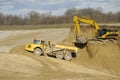 Yellow dump trucks and excavator are working in gravel pit Royalty Free Stock Photo