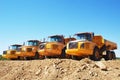 yellow dump trucks on parking