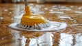 Yellow Dust Mop on Wooden Floor Royalty Free Stock Photo