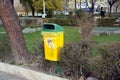 Yellow dustbin in park