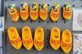 Yellow Dutch clogs magnets as souvenirs from the Netherlands, for travellers. Says Holland and some have wooden tulips. In a