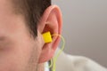 Yellow Earplug Into The Ear Royalty Free Stock Photo