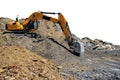 Yellow earth-moving machine on a large pile of sand and debris Royalty Free Stock Photo