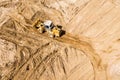 Yellow earthmover adjust elevation level soil for construction site. aerial view Royalty Free Stock Photo
