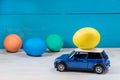 Easter egg in toy car on a blue background Royalty Free Stock Photo