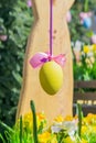 Yellow easter egg hang on blooming apple tree branch. Easter decoration and celebration concept Royalty Free Stock Photo
