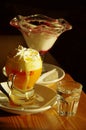 Yellow egg liqueur with whipped cream and a glass of water, vertical orientation