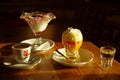 Yellow egg liqueur with whipped cream and a glass of water, horizontal orientation