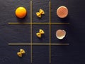 Yellow egg with pasta X and zero game Royalty Free Stock Photo