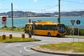 A yellow electric bus waits at the terminus by the side of Lyall Bay, Wellington, New Zealand