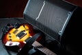 Yellow electric guitar and black amplifier on a dark background, close-up Royalty Free Stock Photo