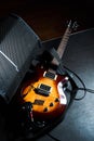 Yellow electric guitar and black amplifier on a dark background, close-up Royalty Free Stock Photo