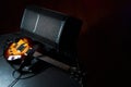 Yellow electric guitar and black amplifier on a dark background, close-up Royalty Free Stock Photo