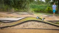 Yellow electric RC buggy racing on an offroad track