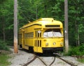 Yellow electric streetcar on tracks