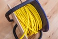 Yellow electric wire extension cord on the reel