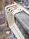 Yellow electrical conduit row with the metal clamp
