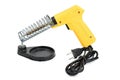 Yellow electrical solder on soldering iron stand.