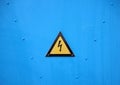 Yellow Electrical Warning Triangle Sign on Blue Background