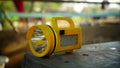 Yellow Electricity Torch closeup isolated on grey column. Yellow battery view, source of illumination to remove darkness Royalty Free Stock Photo