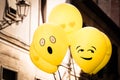 Yellow Emoji balloons floating at a street party