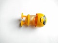 Yellow emoticon doll with spring in the middle