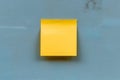 Yellow empty memo note pad stuck to blue wall Royalty Free Stock Photo