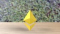 Yellow Ethereum gold sign icon on wood table on leaves background. 3d render isolated illustration, cryptocurrency, crypto,