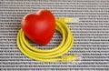 Yellow Ethernet cable and red heart on white background with numbers Royalty Free Stock Photo