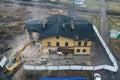 Yellow excavator destroys building. Heavy duty machine is demolishing a brick building. Demolition of the building . Demolition