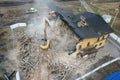 Yellow excavator destroys building. Heavy duty machine is demolishing a brick building. Demolition of the building . Demolition