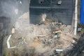 Yellow excavator destroys building. Heavy duty machine is demolishing a brick building. Demolition of the building . Demolition