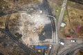 Yellow excavator destroys building. Heavy duty machine is demolishing a brick building. Demolition of the building . Demolition