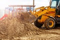 Yellow excavator. Digger machine removing earth in construction site Royalty Free Stock Photo