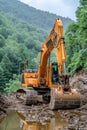 A yellow excavator is digging a hole in the mud in a forest, working on the soil Royalty Free Stock Photo
