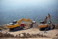 Yellow excavator is filling a dump truck with rocks at coal mines Royalty Free Stock Photo