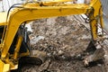 yellow excavator hydraulic engine or macro truck working in house construction site separate garbage on soil Royalty Free Stock Photo